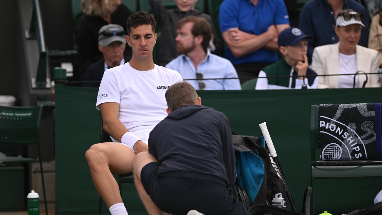 LONDON, ENGLAND - JULY 04: Thanasi Kokkinakis of Australia receives medical treatment before retiring injured during in his Gentlemen's Singles second round match against Lucas Pouille of France during day four of The Championships Wimbledon 2024 at All England Lawn Tennis and Croquet Club on July 04, 2024 in London, England. (Photo by Mike Hewitt/Getty Images)