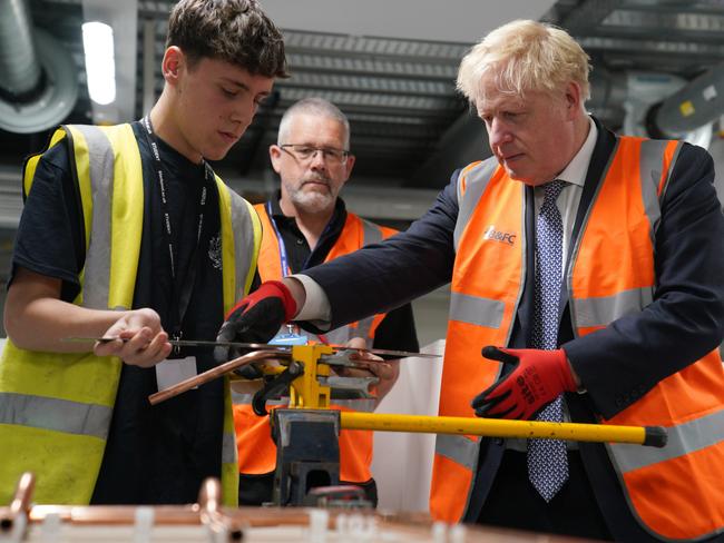 Boris Johnson takes part in a brick laying lesson at Blackpool where he made housing announcements. Picture: WPA Pool/Getty Images