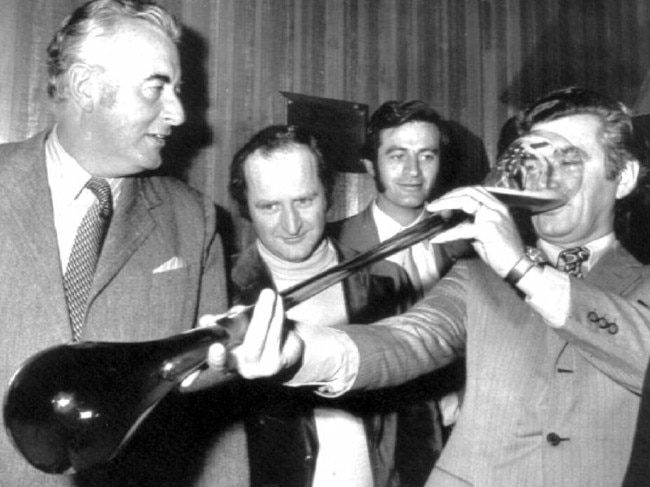 Bob Hawke drinks from a yard glass in front of Gough Whitlam in the 1970s. Picture: Supplied