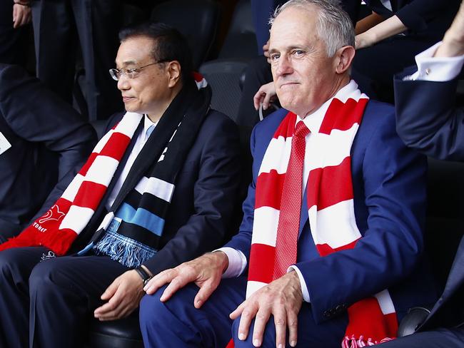 Australia's Prime Minister Malcolm Turnbull sits with Chinese Premier Li Keqiang as they watch an AFL game on Saturday. Picture: David Gray