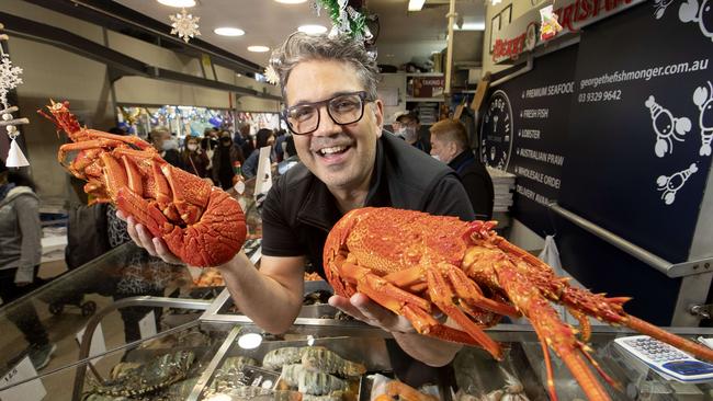 George Milonas, with ‘the Cray Twins’, is flying in more lobsters for his store at Melbourne’s Queen Victoria Market after he sold out on Wednesday. Picture: David Geraghty