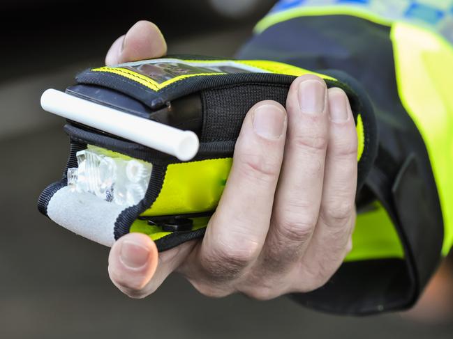 Belfast, Northern Ireland. 24 Nov 2016 - A police officer holds a roadside breathalyser alcohol breath test after taking a sample from a driver.