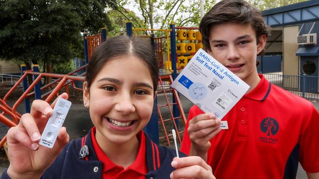 Jells Park Primary School students Anastasia and Ben with a rapid antigen test kit. Picture: :Ian Currie