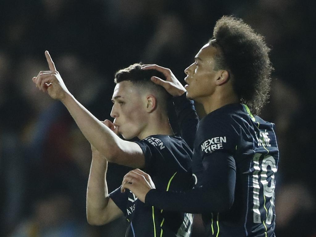 Manchester City's Phil Foden, left, celebrates with his teammate Leroy Sane after scoring his side's third goal during the English FA Cup fifth round soccer match between Newport County and Manchester City at Rodney Parade stadium in Newport, Wales, Saturday, Feb. 16, 2019. (AP Photo/Frank Augstein)