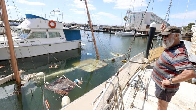 Dieter Czora surveys the damage of his neighbours boat that sunk last week at the Newport Marina Picture: Kelly Barnes