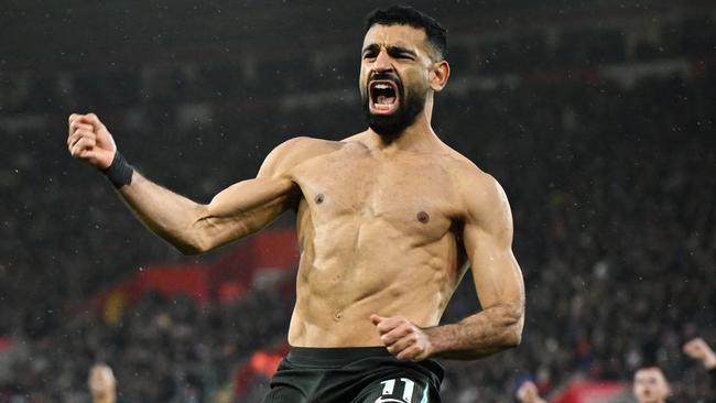 Liverpool's Egyptian striker #11 Mohamed Salah (R) celebrates after shooting a penalty kick and scoring his team third goal during the English Premier League football match between Southampton and Liverpool at St Mary's Stadium in Southampton, southern England on November 24, 2024. (Photo by JUSTIN TALLIS / AFP) / RESTRICTED TO EDITORIAL USE. No use with unauthorized audio, video, data, fixture lists, club/league logos or 'live' services. Online in-match use limited to 120 images. An additional 40 images may be used in extra time. No video emulation. Social media in-match use limited to 120 images. An additional 40 images may be used in extra time. No use in betting publications, games or single club/league/player publications. /