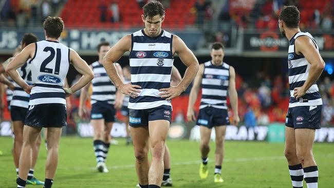 Geelong players walk off Metricon Stadium after losing to Gold Coast.