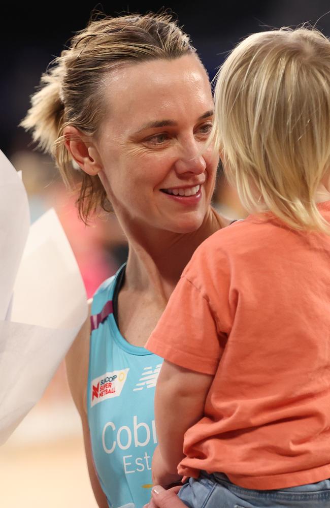 Nat Medhurst with one of her children during her comeback to Super Netball with the Melbourne Mavericks. Picture: Kelly Defina/Getty Images
