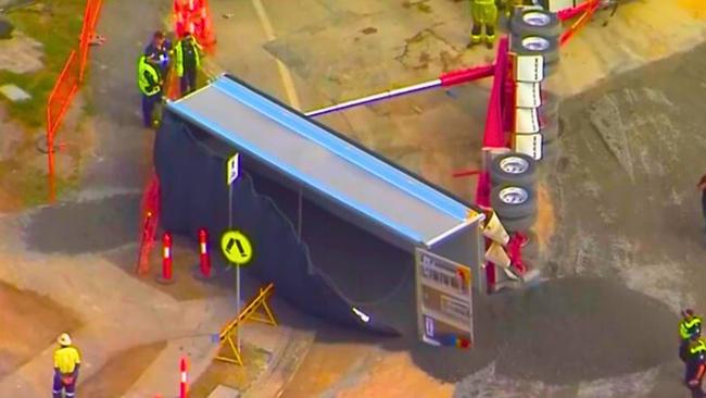 A truck trailer on its side at the scene of the incident at Victoria Point, where Cleveland-Redland Bay Rd is being widened at Benfer Rd opposite the Victoria Point State High School. Picture: Courtesy 7 News.com.au