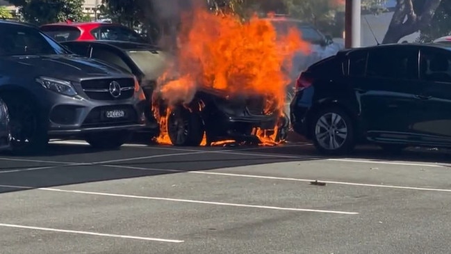 A car has exploded after catching fire in the Runaway Bay Shopping Centre car park. Picture: Calvin Swain