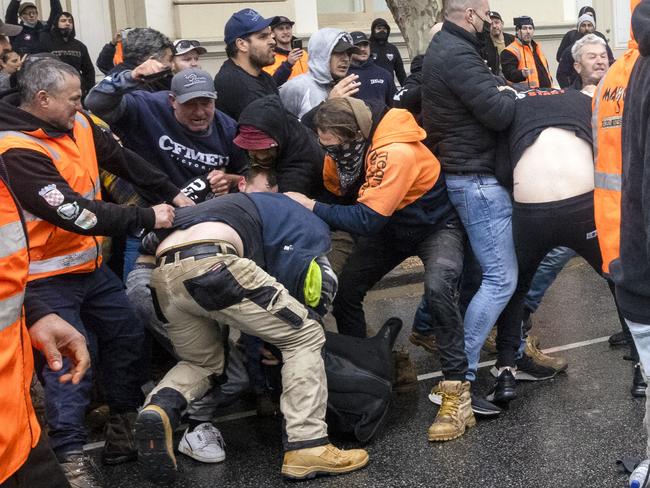 MELBOURNE, AUSTRALIA - NewsWire Photos September 20, 2021:  CFMEU members brawl with each other outside the CFMEU headquarters in Melbourne during a protest about mandatory vaccination in the construction industry.Picture: NCA NewsWire / David Geraghty