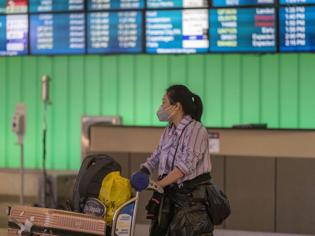 A traveller takes precautions at Los Angeles International Terminal on Sunday. Picture: David McNew/Getty Images/AFP