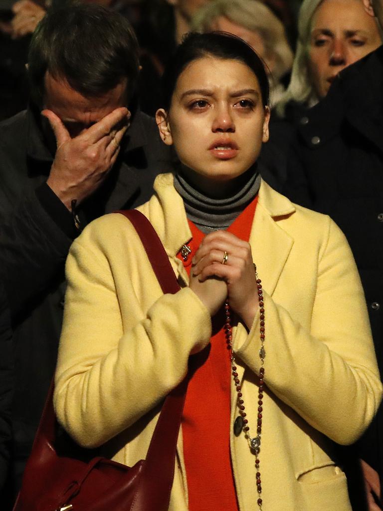 People said prayers in front of the cathedral and wept as they watched the building burn. Picture: Christophe Ena