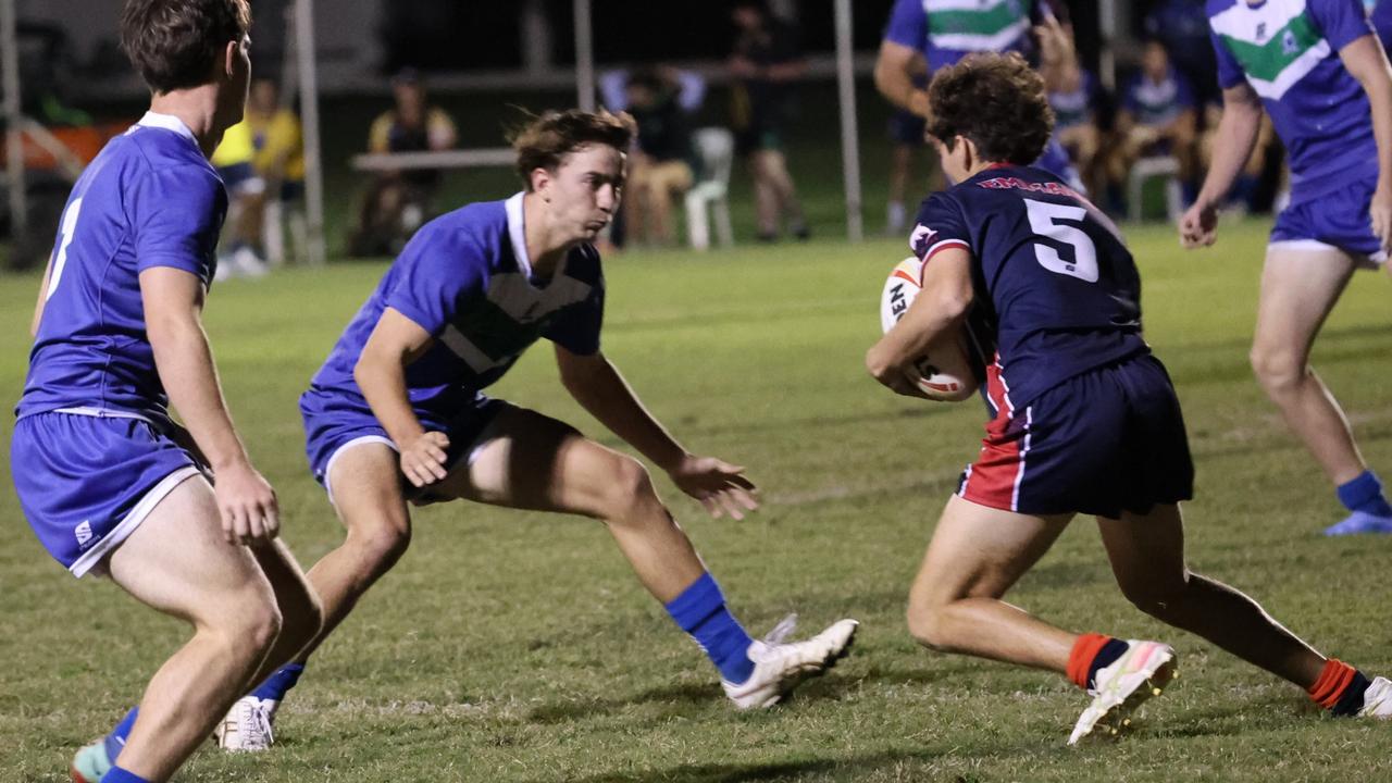 The Cathedral College second rower Jake Armstrong (centre) prepares to land another tackle during a big game against Emmaus.