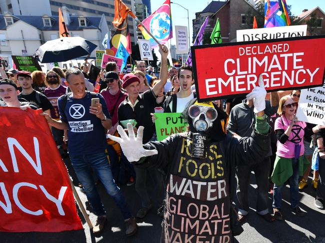 Extinction Rebellion protestors are seen blocking the corner of Margaret and William Streets in Brisbane, Tuesday, August 6, 2019. Climate change protestors are planning to shut down Brisbane's CBD. (AAP Image/Darren England). NO ARCHIVING
