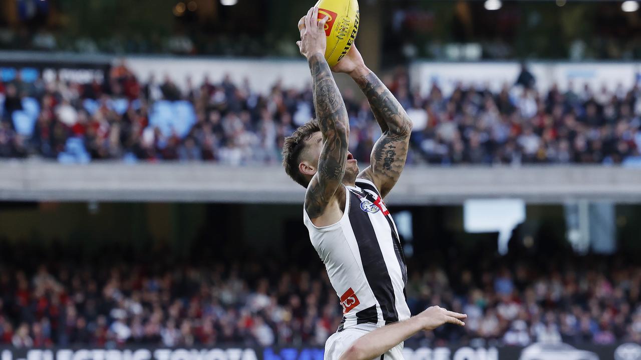 MELBOURNE , AUSTRALIA. April 25, 2024. AFL.. Anzac Day. Essendon vs Collingwood at the the MCG. Jamie Elliott of the Magpies marks over Ben McKay of the Bombers during the 3rd qtr. . Pic: Michael Klein