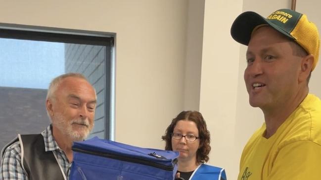 Nationals Candidate for the seat of Lismore Alex Rubin, of Tenterfield, giving the ballot box a lucky shake.