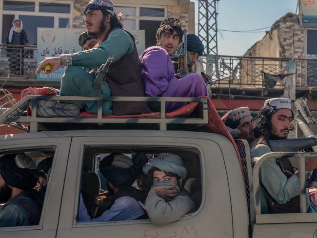 Taliban members drive along a road in the centre of Kabul on October 14, 2021. Picture: Bulent Kilic / AFP