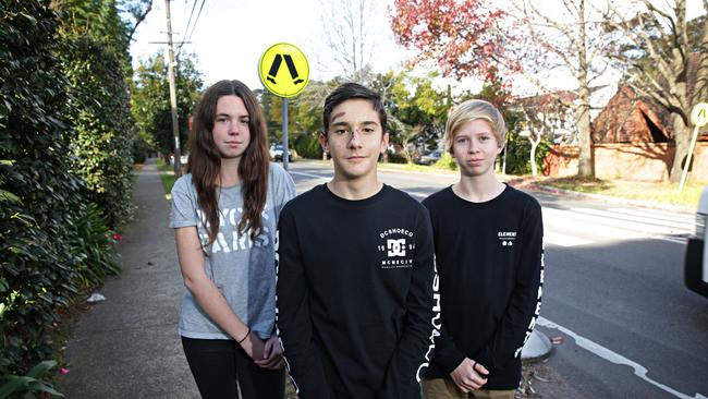 Samantha Pugh, Frankie Parrino and Moses Dorsey at the pedestrians crossing where they were hit by a car in Frenches Forest. Picture: Adam Yip