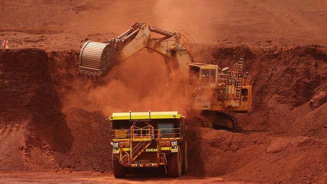 An excavator loads ore into an autonomous dump truck in the Pilbara region, Australia. Picture: Brendon Thorne/Bloomberg via Getty Images.