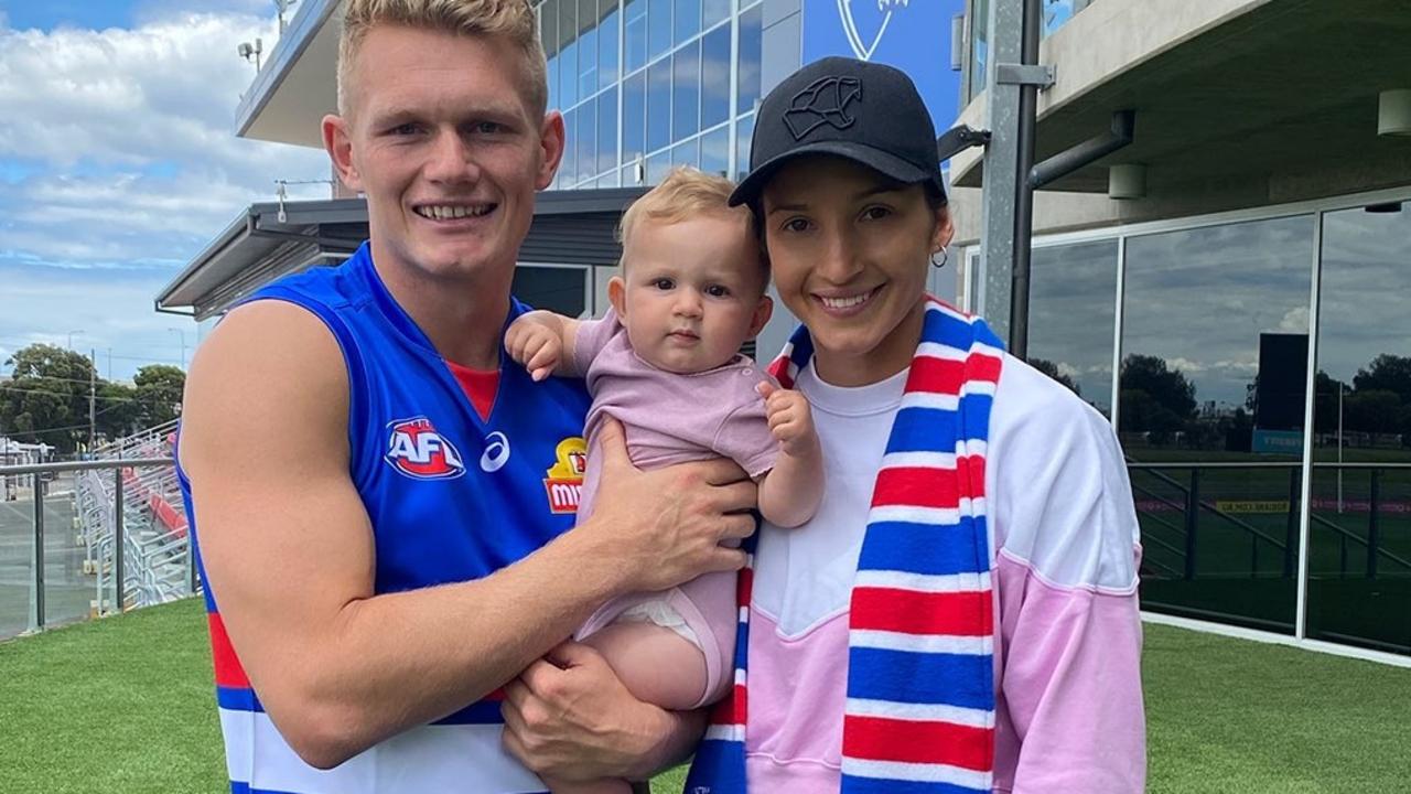 Firebirds vice captain Kim Ravallion and her partner, Western Bulldog player Adam Treloar with their daughter Georgie