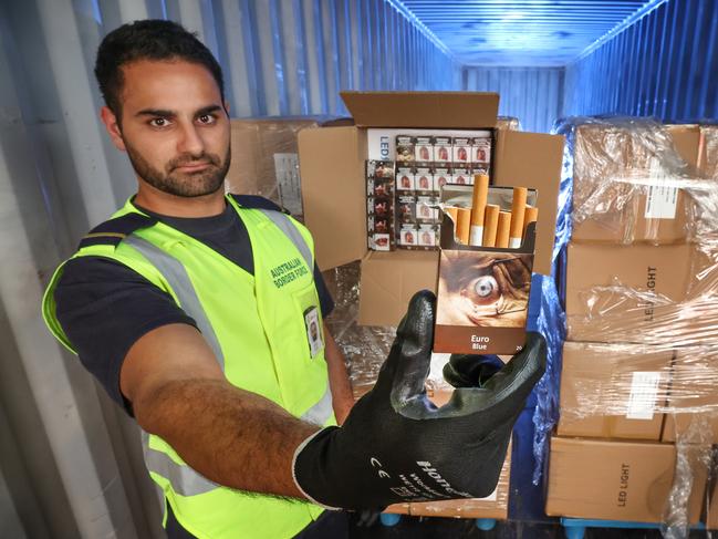 Australian Border Force container checks at Melbourne's docks. There are hundreds of millions of illegal cigarettes coming into Australia each year despite increasing checks. An Australian Border Force Customs officer with a concealed shipment of cigarettes boxed as LED lights from China found in a container.                      Picture: David Caird