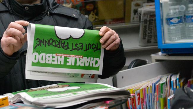 PARIS, FRANCE - JANUARY 14: A man buys a copy of the new edition of Charlie Hebdo magazine at a Pigalle newsstand on January 14, 2014 in Paris, France. Three million copies of the controversial magazine have been printed in the wake of last week's terrorist attacks. (Photo by Aurelien Meunier/Getty Images)