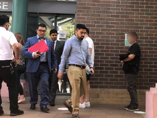 Poudel (blue shirt, beige trousers) left court with his lawyer Anthony Sukkar