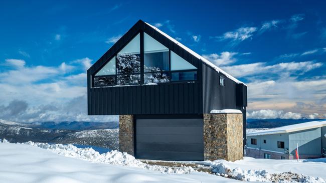 The four-bedroom and four-bathroom 12 Skyline Tce at Mt Hotham, an architecturally designed, bold metal and stone-clad house with internal car spaces. The asking price is $2.75m.