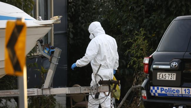 A forensic investigator attends a home in Pendle Hill where a woman in her 80s died from Covid-19. Picture: Jonathan Ng