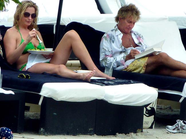 Penny Lancaster and Rod Stewart with family poolside at Palazzo Versace.