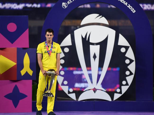 AHMEDABAD, INDIA - NOVEMBER 19: Australia captain Pat Cummins holds the trophy as he waits for team after receiving the trophy from Narendra Modi, Prime Minister for India during the ICC Men's Cricket World Cup India 2023 Final between India and Australia at Narendra Modi Stadium on November 19, 2023 in Ahmedabad, India. (Photo by Gareth Copley/Getty Images)