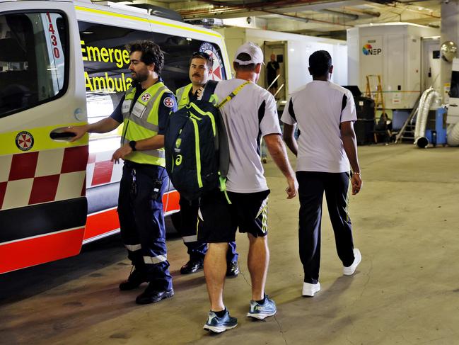 Bumrah (right) walks through the bowels of the SCG to a waiting car. Picture: Sam Ruttyn