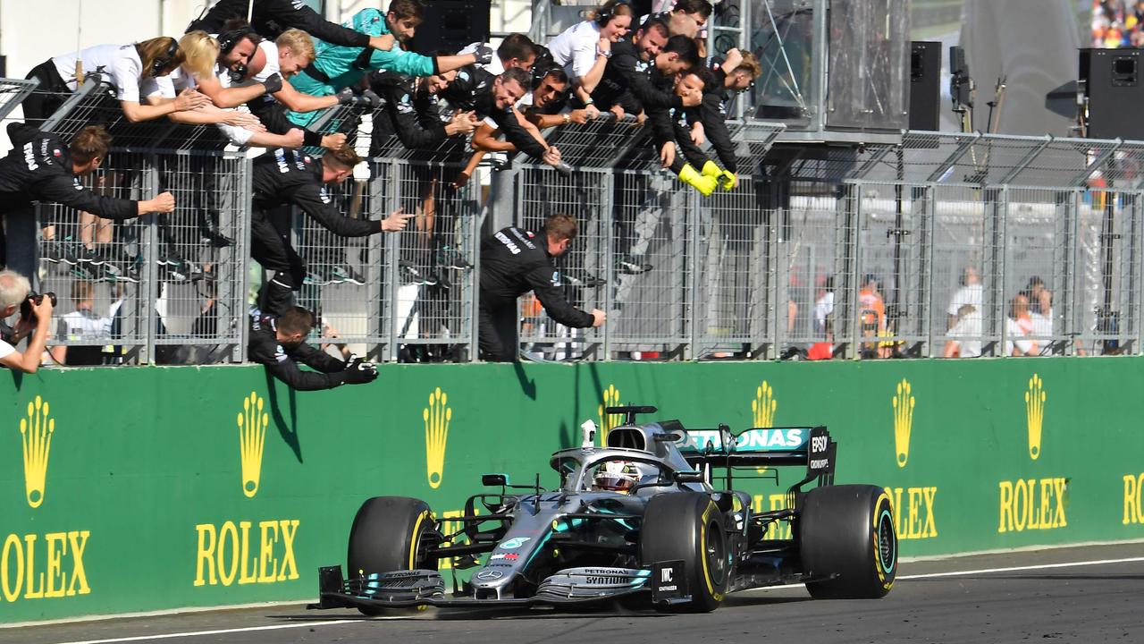 Hamilton celebrates with his teammates after winning the Hungarian Grand Prix.