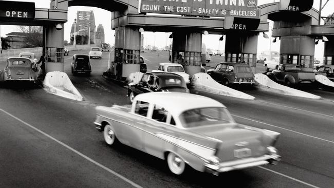 EMBARGO SUNDAY DEC 22 .   NEWS 360 PREMIUM LOCKED CONTENT – NO THE AUSTRALIAN/NO NEWS.COM/NO SKY NEWS: AN AUSTRALIAN GEOGRAPHIC BOOK - IN LIVING MEMORY - BY ALASDAIR MCGREGOR.    Southern tollbooths, Sydney Harbour Bridge,1959. On the bridge’s opening in 1932, cars andmotorcycles with sidecars paid a toll of 6d in eachdirection, while bicycles, tricycles, motorcycleswithout sidecars, as well as horseriders, each paid3d. In the early days there were no booths and tollcollectors stood out in the open in all weathers.