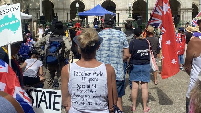 At the protest outside Queensland Parliament a woman's shirt reads "Teacher Aide, 11+ years, Special Ed, Manual Arts, Banned from school site, no jab no job". Picture: Samantha Scott.