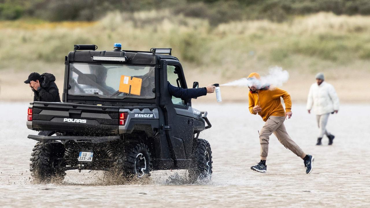 French National Police launch tear gas from a buggy vehicle to disperse migrants to prevent them from boarding a smuggler's boat in an attempt to cross the English Channel in northern France. Picture: Sameer Al-Doumy/AFP