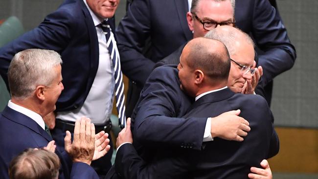 Prime Minister Scott Morrison hugs Treasurer Josh Frydenberg after handing down his first Federal Budget. Picture: AAP Image/Mick Tsikas