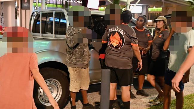 Fire project team members calm a frenzied situation on a Cairns CBD street. Picture: Isaac McCarthy