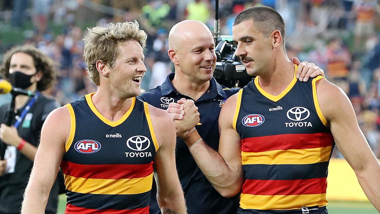 Matthew Nicks chats to Taylor Walker and Rory Sloane after a match last season.