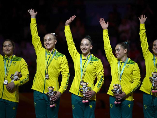 Silver medallists (from L) Australia's Georgia Godwin, Australia's Emily Whitehead, Australia's Romi Brown, Australia's Breanna Scott and Australia's Kate McDonald pose with their medals during the medal ceremony of the women's team artistic gymnastics event at the Arena Birmingham, in Birmingham on day two of the Commonwealth Games in Birmingham, central England, on July 30, 2022. (Photo by Ben Stansall / AFP)