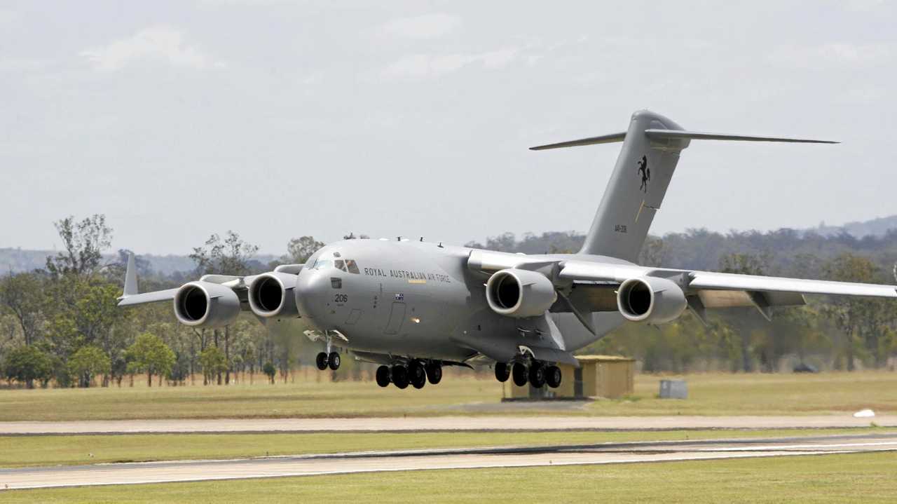 Massive grey plane pretends to land at Mackay Airport | The Courier Mail