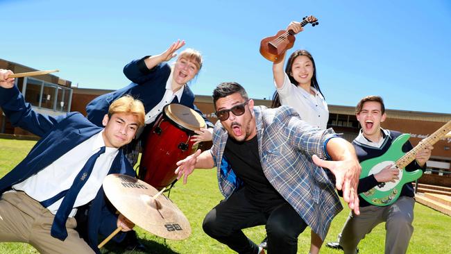 Music students from St Andrews College, Lolec Suarez, Anna Kravtsova, Katherine Kim and Ryan Oxley celebrate their music teacher Antonio Chiappetta being nominated for music teacher of the year at the Aria Awards. Picture: Angelo Velardo