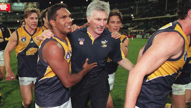 Mick Malthouse celebrates a win with his West Coast players.