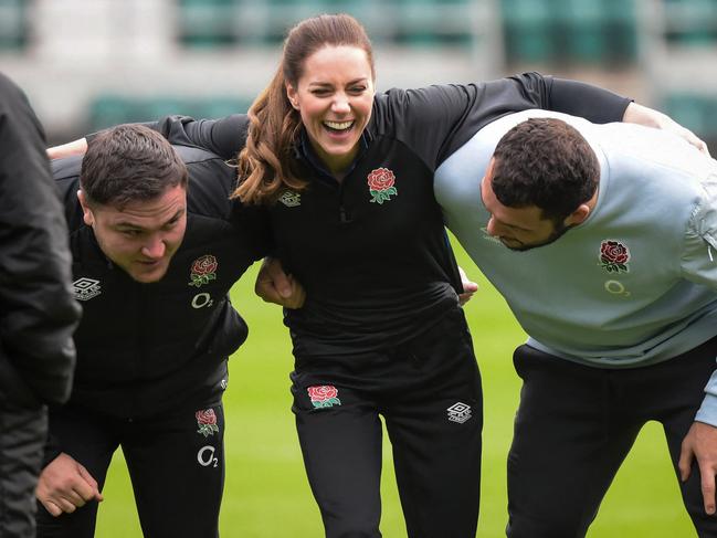 Britain's Catherine, Duchess of Cambridge flanked England's rugby players Ellis Genge and Jamie George as she takes part in England's rugby teams training sessions. Picture: Getty