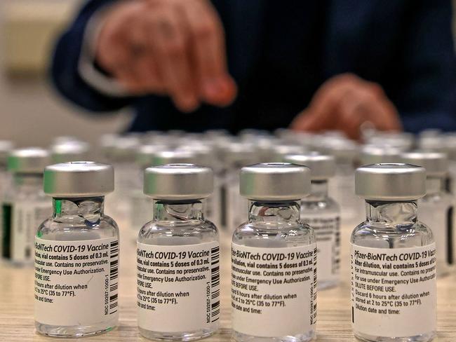 A health worker handles empty vials of the Pfizer-BioNtech COVID-19 vaccine at a Clalit Health Services vaccination clinic in the Palestinian neighbourhood of Beit Hanina, in Israeli-annexed east Jerusalem on February 3, 2021. (Photo by AHMAD GHARABLI / AFP)