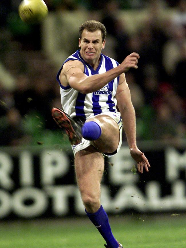 Wayne Carey kicks for North Melbourne.