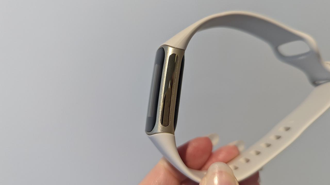 Fitbit Charge 5 users can complete an ECG or EDA scan by holding the metal sides of the tracker. Image: Lauren Chaplin/news.com.au