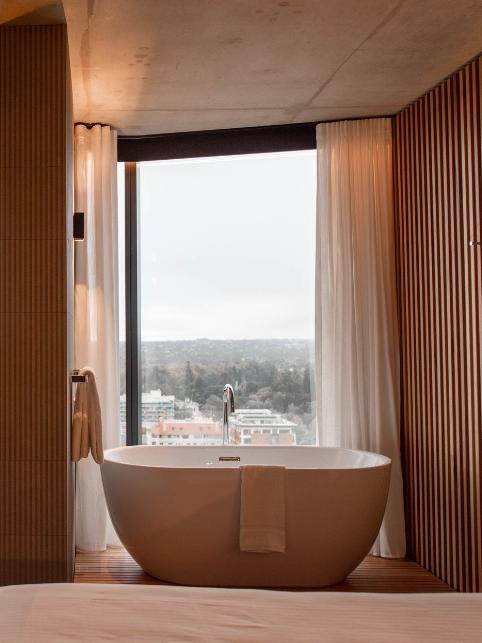 The bathtubs with a view at the Vibe Hotel on Franklin St are fitted with curtains for guests' privacy. Picture: Supplied