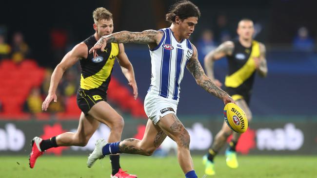 Marley Williams of the Kangaroos takes a kick. (Photo by Chris Hyde/Getty Images)